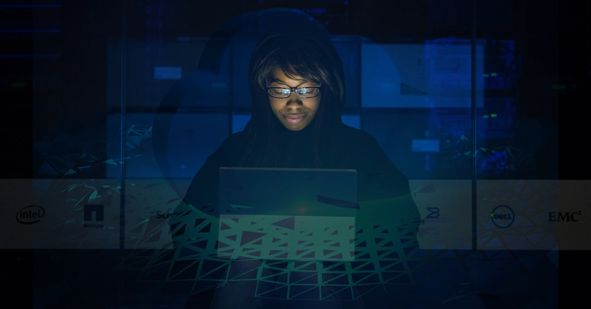 Smiling IT professional working on a laptop in a data center, symbolising cloud computing and managed ICT companies services in South Africa